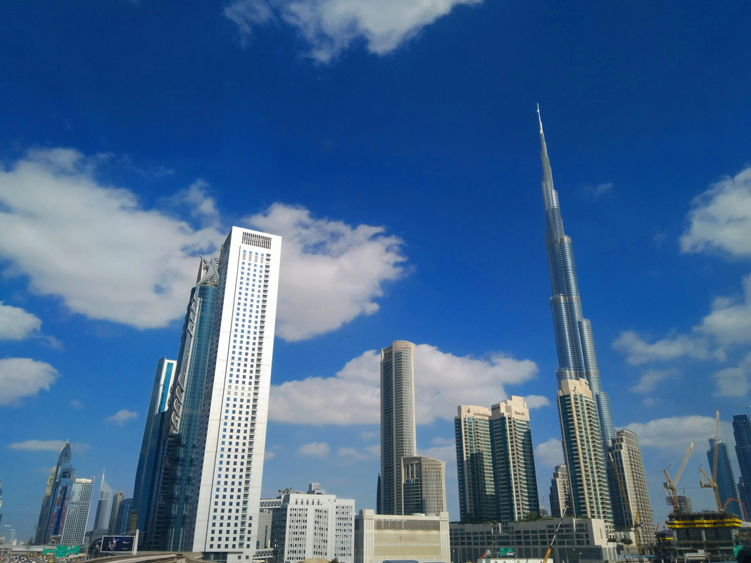 Downtown Dubai and Burj Khalifa skyline on a nice day with a blue sky and clouds.