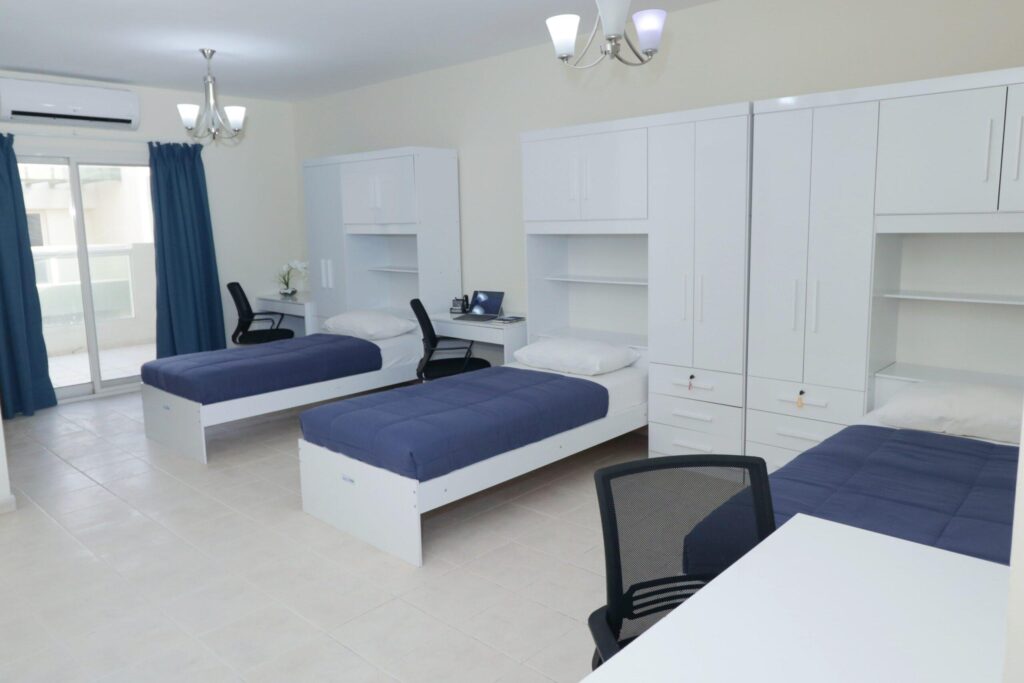 Shared bedroom with multiple beds in a Dubai apartment set up for shared housing