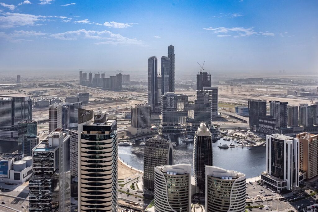 Construction workers on an off-plan tower development in Dubai with cranes in the background