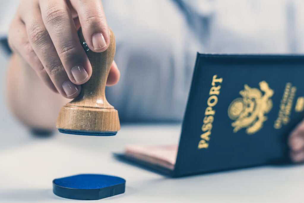 Passport being stamped, representing UAE visa and residency processing